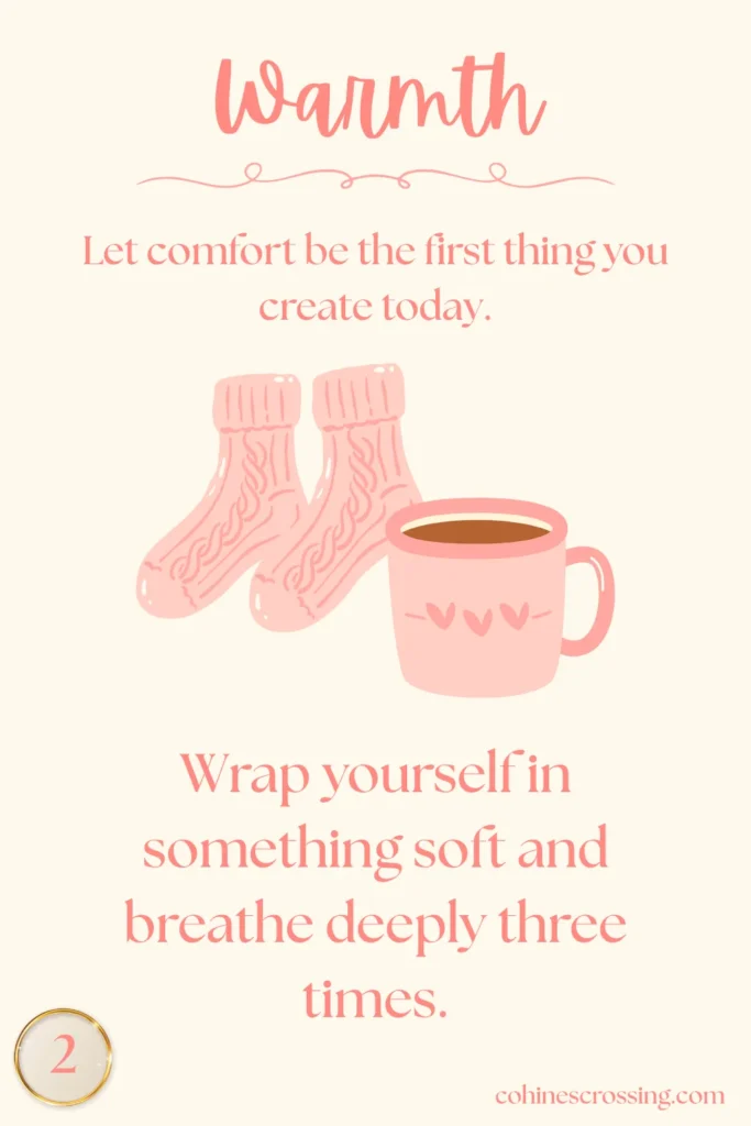 "Warmth" written on a cream oracle card with a thought, a cozy pair of socks, and a pink mug with an action step and the number 2