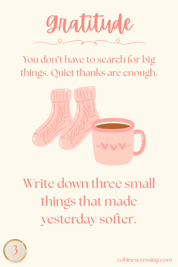 Word “gratitude” on an oracle card that has a gratitude thought and action step with a cozy cup of coffee and a pair of socks